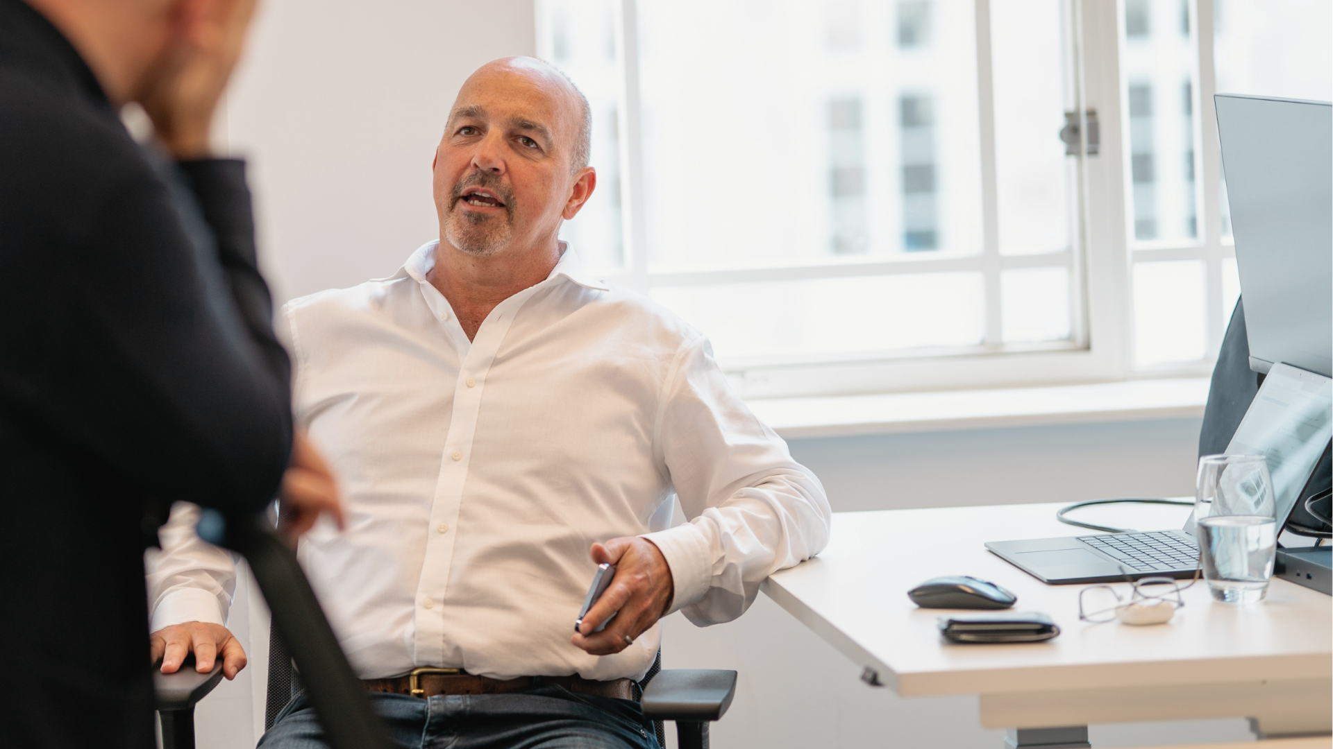 Kevin Elderfield discussing with another team member from Erevena